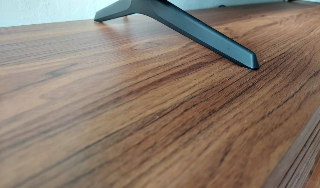 The depth of the Wilson TV Stand is 13.75", the depth of the TV base is greater than 11", like mine, there's not a lot of room for error when it comes to kids bumping into it for the TV to stay on the stand.